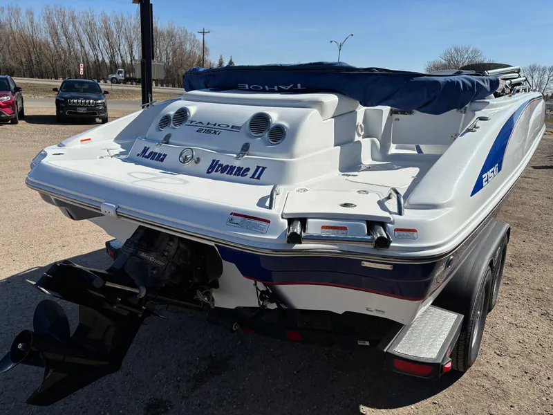 Slide: The Image of 2020 Tahoe 215 Xi boat on trailer, rear view, parked outdoors. - 4
