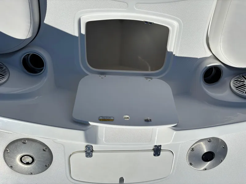 Slide: The Image of 2020 Tahoe 215 Xi boat interior with storage compartment and speakers. - 8