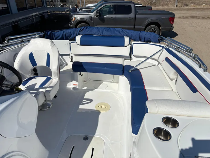 Slide: The Image of 2020 Tahoe 215 Xi boat interior with blue and white seating and cup holders. - 9