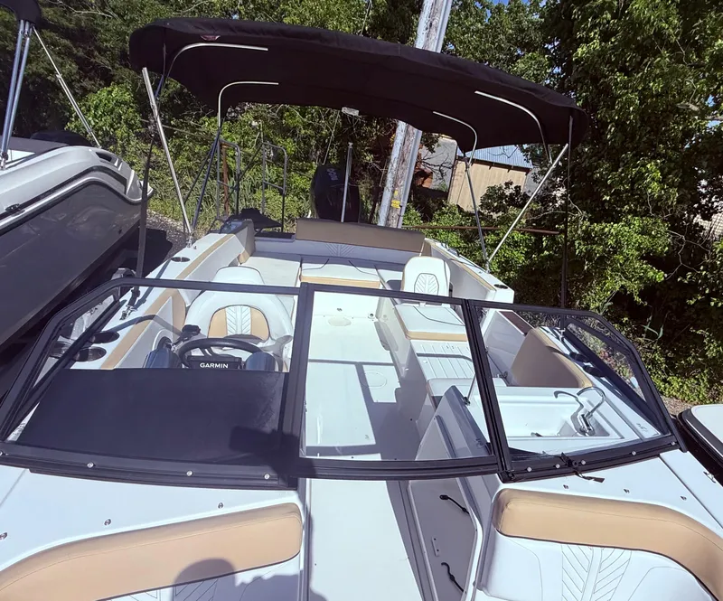 Slide: The Image of 2022 Glastron/Carlson GTD 220 boat with canopy, parked outdoors. - 11