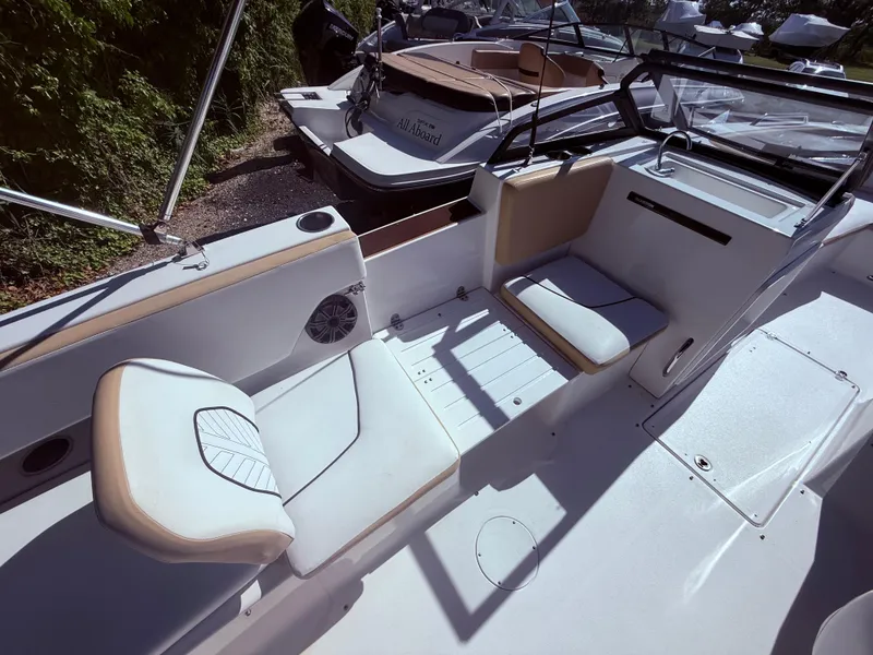 Slide: The Image of 2022 Glastron/Carlson GTD 220 boat interior with white seating and modern design. - 13