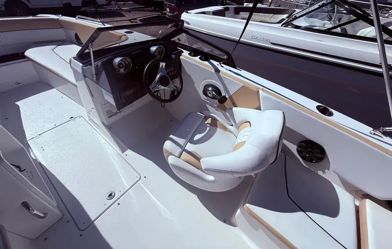 Slide: The Image of 2022 Glastron/Carlson GTD 220 boat interior with steering wheel and seating. - 14