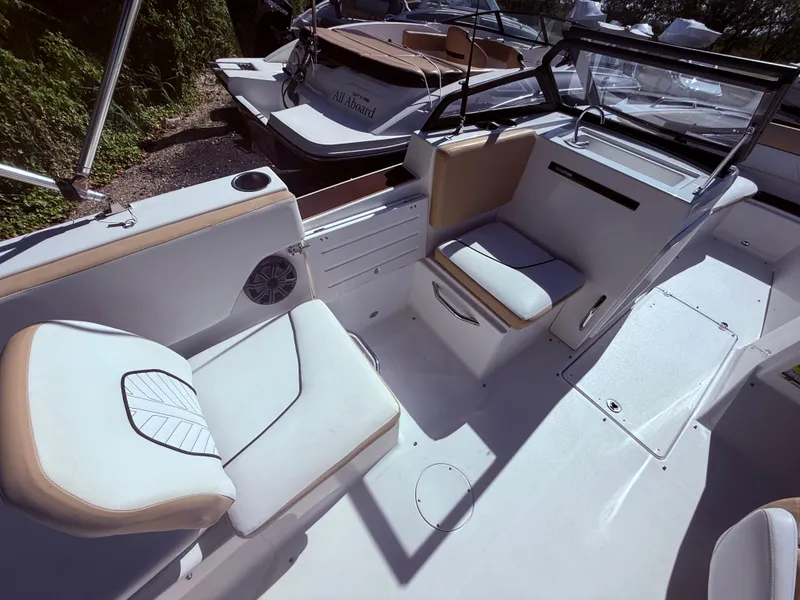 Slide: The Image of 2022 Glastron/Carlson GTD 220 boat interior with white and tan seating. - 15