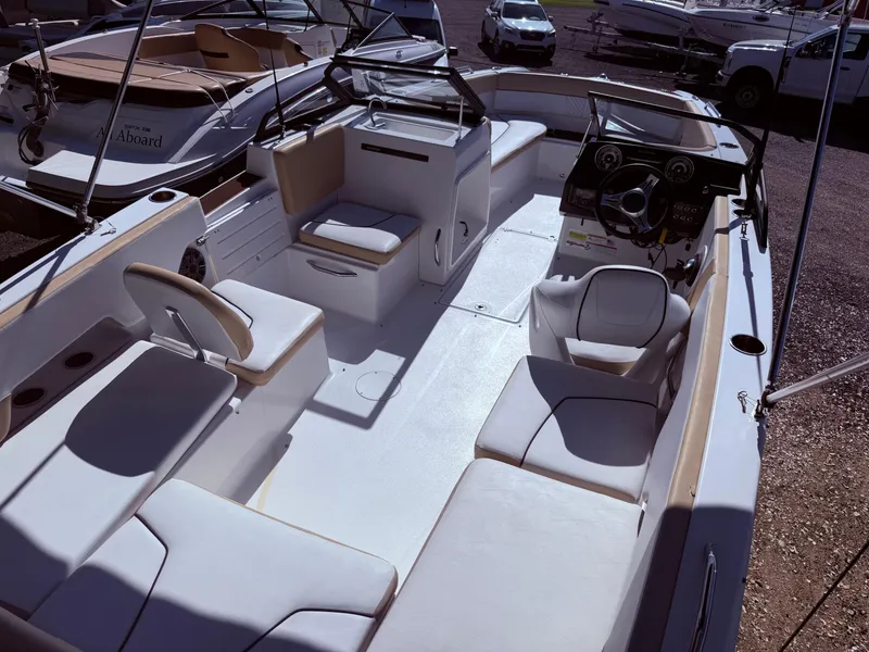 Slide: The Image of 2022 Glastron/Carlson GTD 220 boat interior with white seating and modern dashboard. - 17