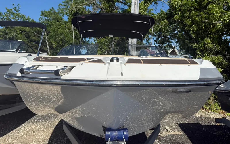 Slide: The Image of 2022 Glastron/Carlson GTD 220 boat with canopy, parked outdoors. - 5