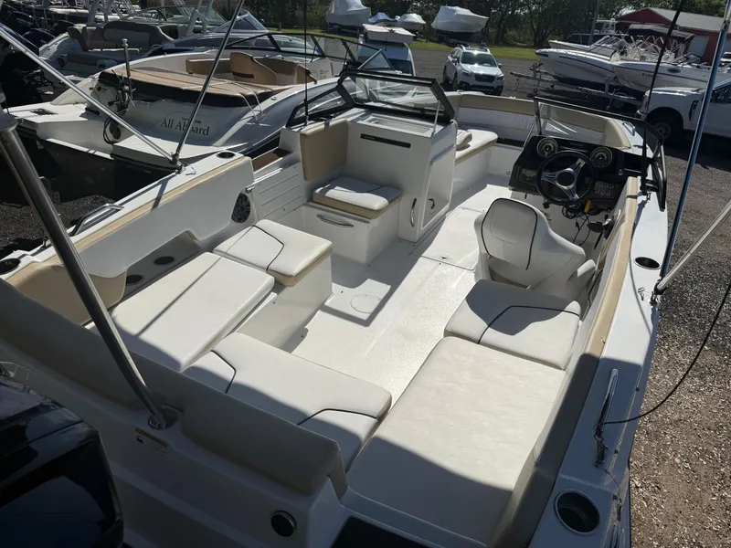 Slide: The Image of 2022 Glastron/Carlson GTD 220 boat interior with spacious seating and modern dashboard. - 6