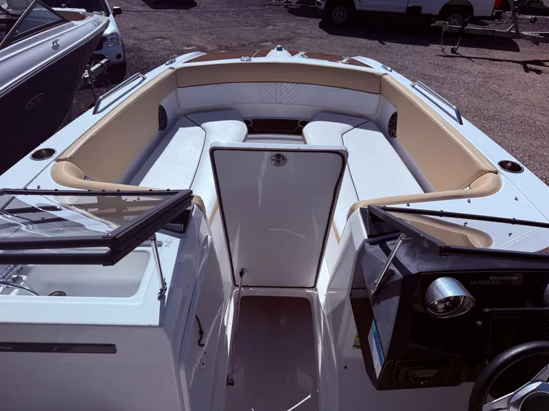 Slide: The Image of 2022 Glastron/Carlson GTD 220 boat interior with beige seating and steering console. - 7