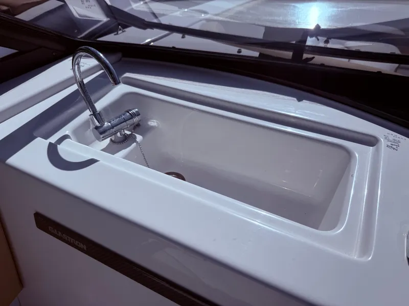 Slide: The Image of 2022 Glastron/Carlson GTD 220 boat sink with faucet, close-up view. - 8