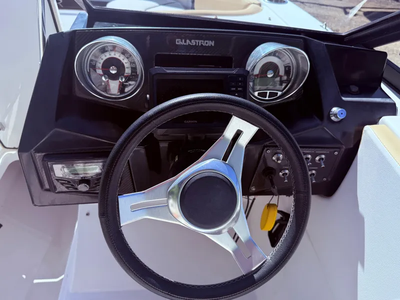 Slide: The Image of Steering wheel and dashboard of 2022 Glastron/Carlson GTD 220 boat. - 9