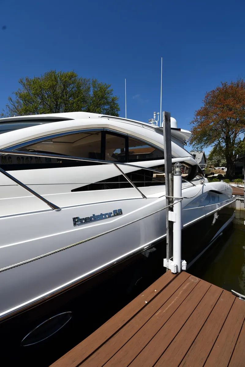 Slide: The Image of 2002 Sunseeker 68 Predator yacht docked, showcasing sleek design and luxury features. - 1