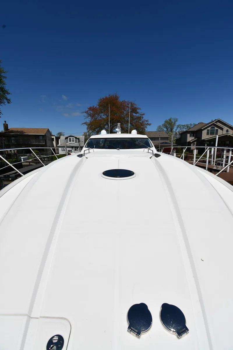 Slide: The Image of 2002 Sunseeker 68 Predator yacht deck under clear blue sky. - 10