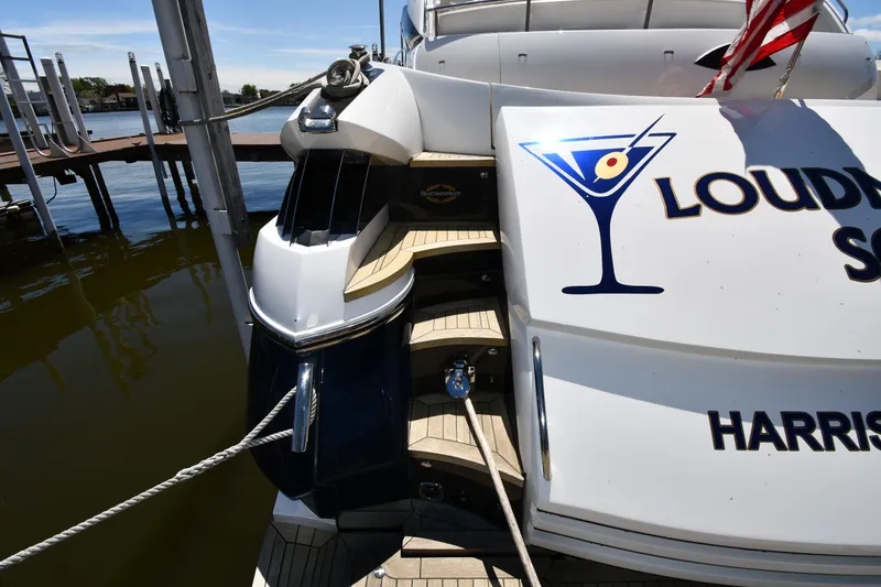 Slide: The Image of Sunseeker 68 Predator yacht docked, featuring sleek design and custom graphics, 2002 model. - 15