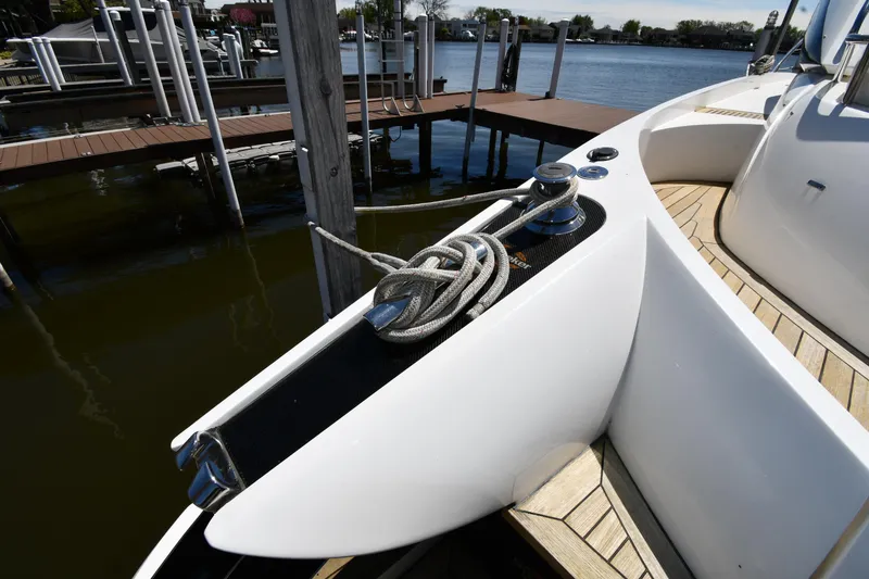 Slide: The Image of Sunseeker 68 Predator 2002 yacht docked, showcasing sleek design and mooring rope. - 17