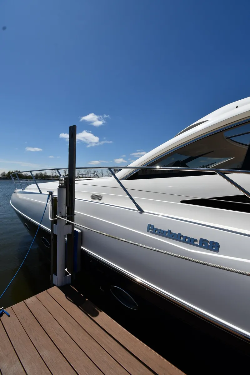 Slide: The Image of 2002 Sunseeker 68 Predator yacht docked under clear blue sky. - 2