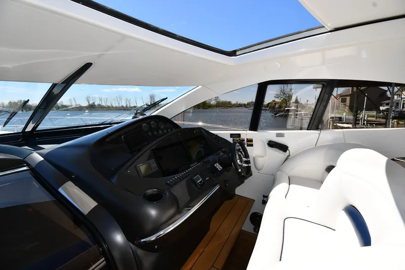 Slide: The Image of Interior view of 2002 Sunseeker 68 Predator yacht cockpit with modern controls and seating. - 21