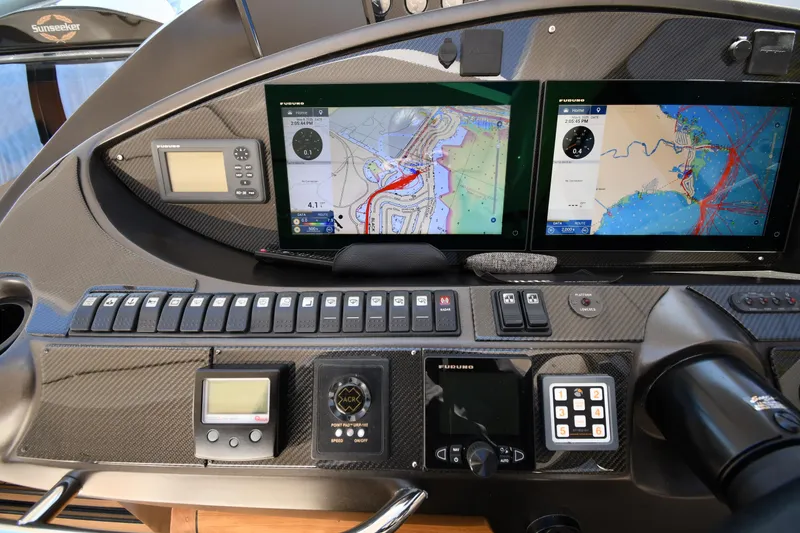 Slide: The Image of Control panel of a 2002 Sunseeker 68 Predator yacht with navigation screens and instruments. - 23