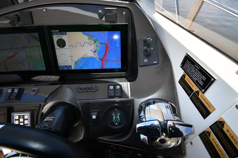 Slide: The Image of Control panel of 2002 Sunseeker 68 Predator yacht with navigation display and throttle controls. - 24