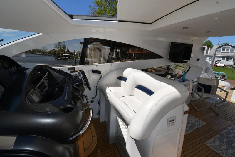 Slide: The Image of Interior view of 2002 Sunseeker 68 Predator yacht with sleek helm and white seating. - 26