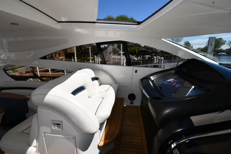 Slide: The Image of Interior of 2002 Sunseeker 68 Predator yacht with white seating and sleek design. - 28