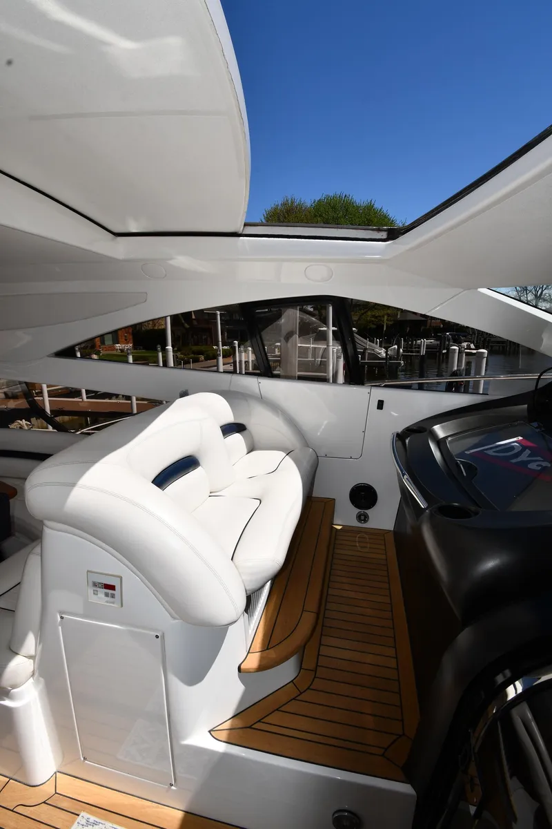 Slide: The Image of Interior view of 2002 Sunseeker 68 Predator yacht with white seating and wooden flooring. - 29