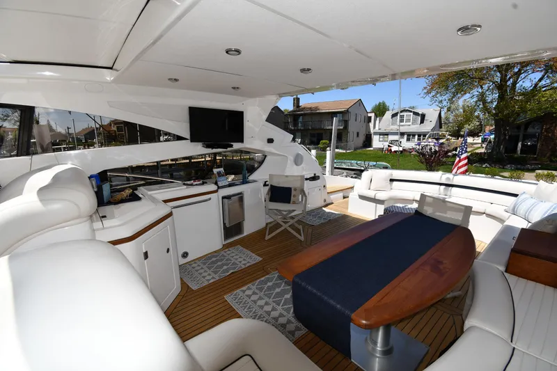 Slide: The Image of Luxurious 2002 Sunseeker 68 Predator yacht interior with elegant seating and modern amenities. - 35