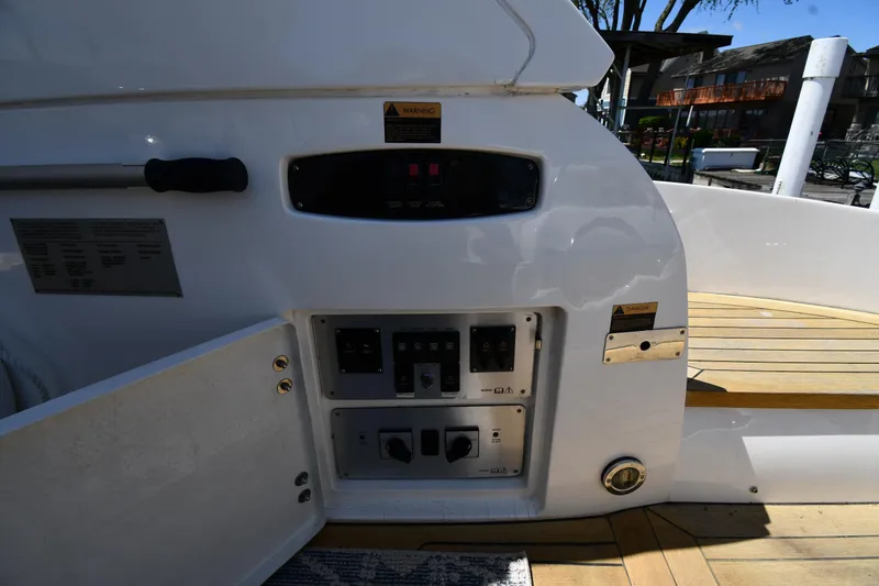 Slide: The Image of Control panel on a 2002 Sunseeker 68 Predator yacht, featuring open access and wooden deck. - 39
