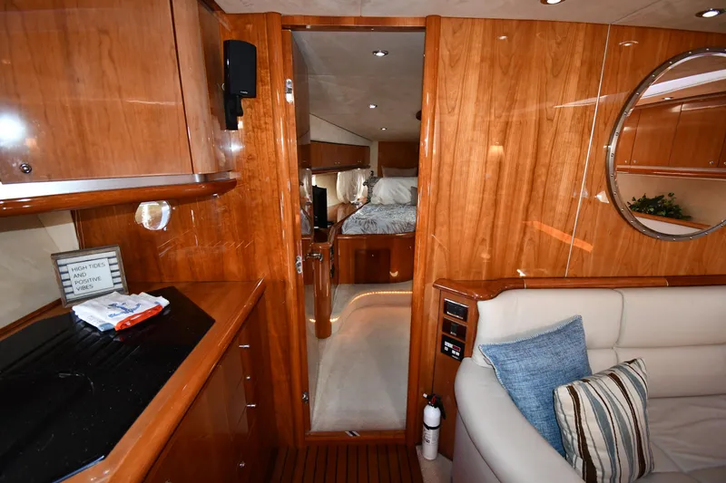 Slide: The Image of Luxurious interior of 2002 Sunseeker 68 Predator yacht with wood finish and cozy seating. - 42