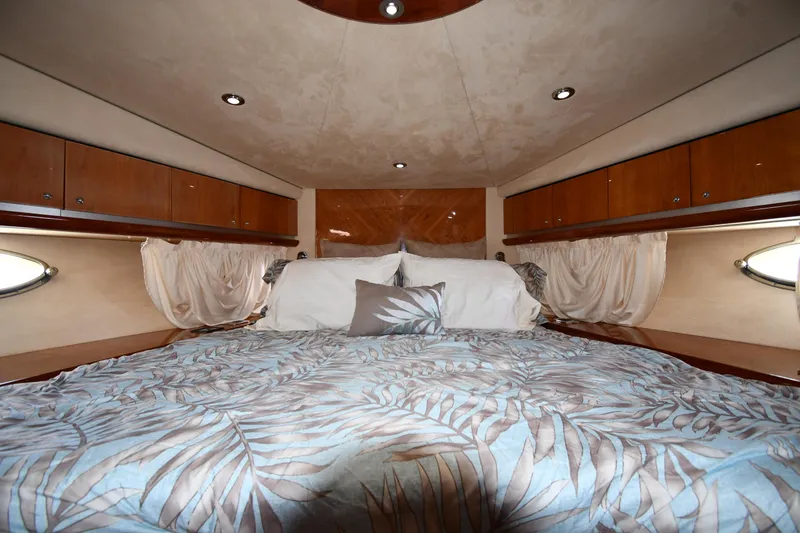 Slide: The Image of Luxurious bedroom interior of 2002 Sunseeker 68 Predator yacht with elegant bedding and wood accents. - 43