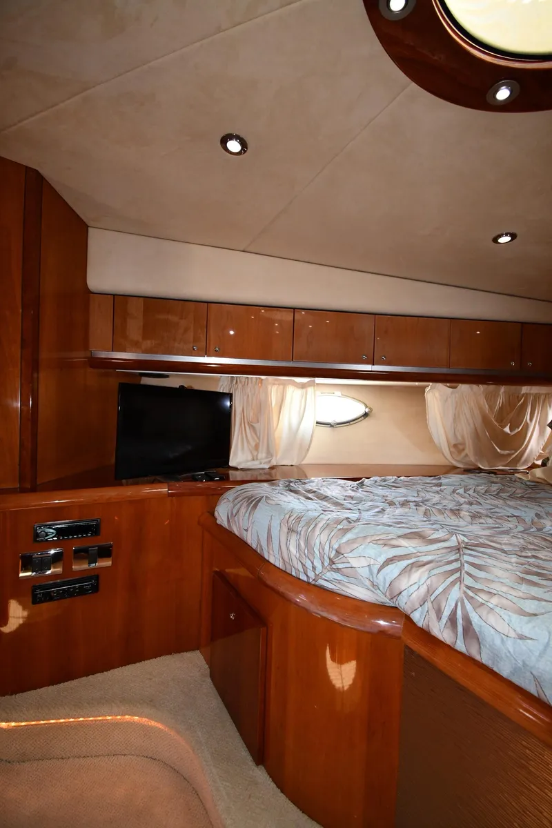Slide: The Image of Luxurious cabin interior of 2002 Sunseeker 68 Predator yacht with wood finish and cozy bedding. - 45