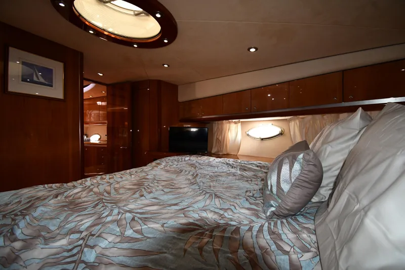 Slide: The Image of Luxurious bedroom interior of 2002 Sunseeker 68 Predator yacht with elegant bedding and wood finishes. - 46