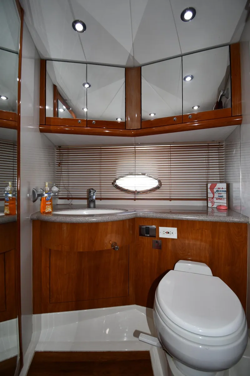 Slide: The Image of Luxurious bathroom in 2002 Sunseeker 68 Predator yacht with modern fixtures and wood accents. - 49
