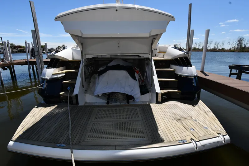 Slide: The Image of Sunseeker 68 Predator 2002 yacht docked, rear view with open storage compartment. - 6