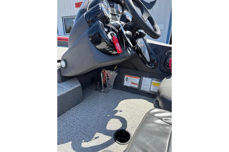 Slide: The Image of 2021 Tracker Pro Team 175 TX boat cockpit with steering wheel and control panel. - 12