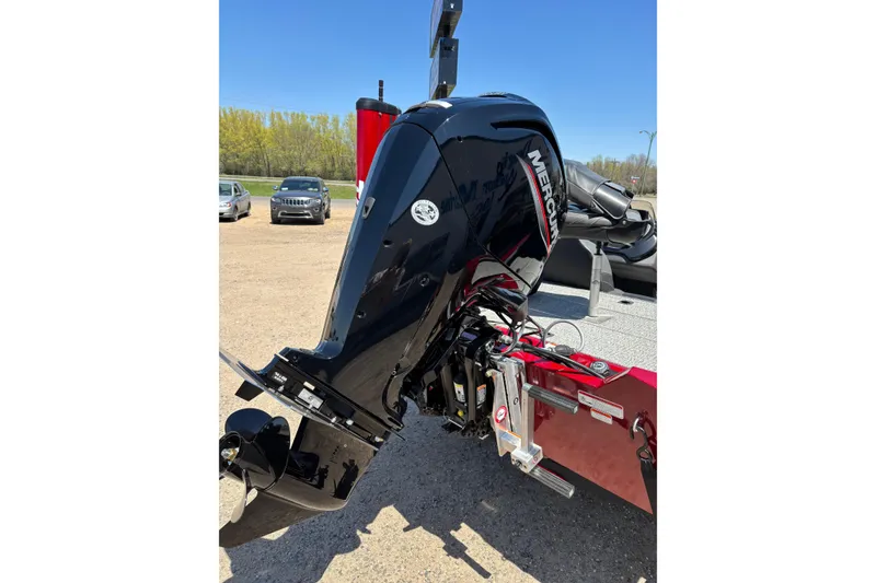 Slide: The Image of 2021 Tracker Pro Team 175 TX with Mercury outboard motor in a parking lot. - 13
