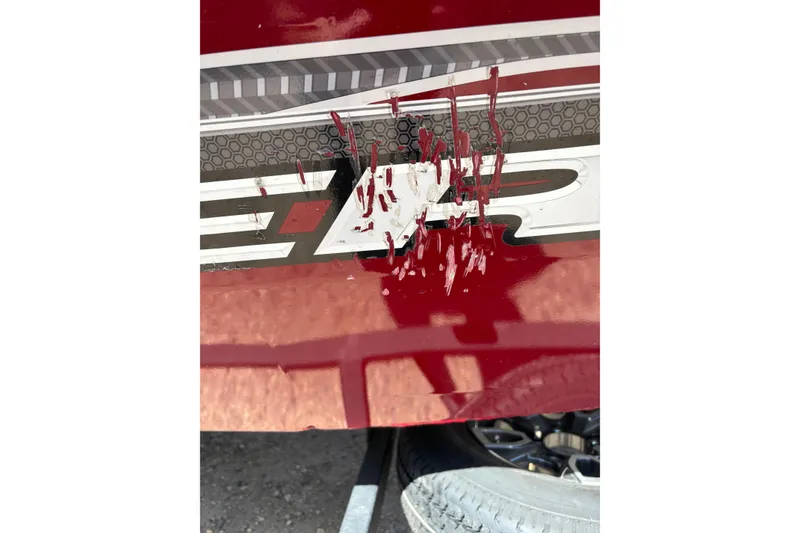 Slide: The Image of 2021 Tracker Pro Team 175 TX with damaged red and white paint on the side. - 9