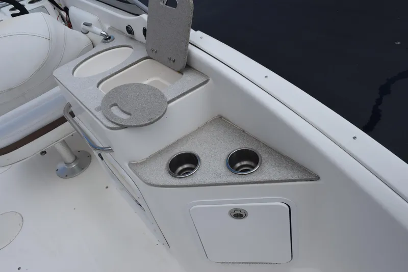 Slide: The Image of 2012 Hurricane SD2200 O/B boat interior with cup holders and storage compartments. - 10