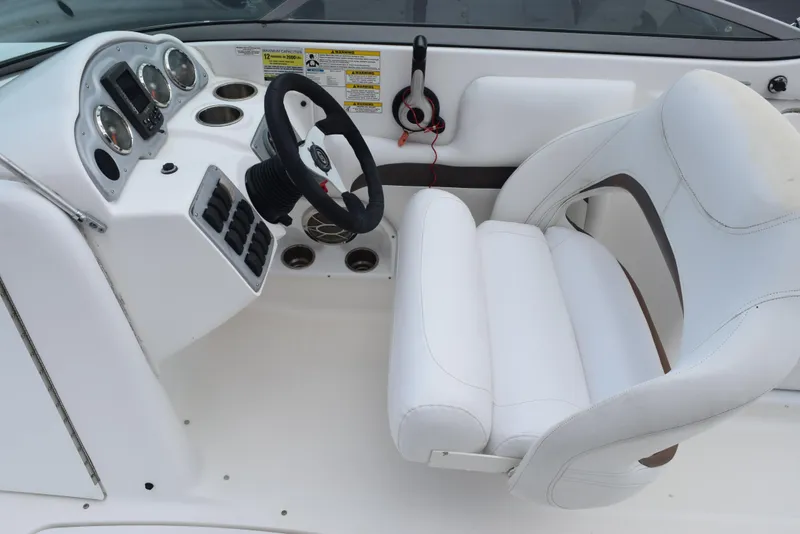 Slide: The Image of 2012 Hurricane SD2200 O/B boat cockpit with white seating and control panel. - 14