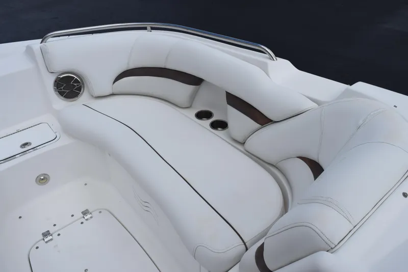 Slide: The Image of 2012 Hurricane SD2200 O/B boat interior with white cushioned seating and cup holders. - 17