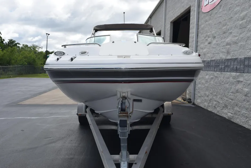 Slide: The Image of 2012 Hurricane SD2200 O/B boat on trailer, parked outside a building. - 3