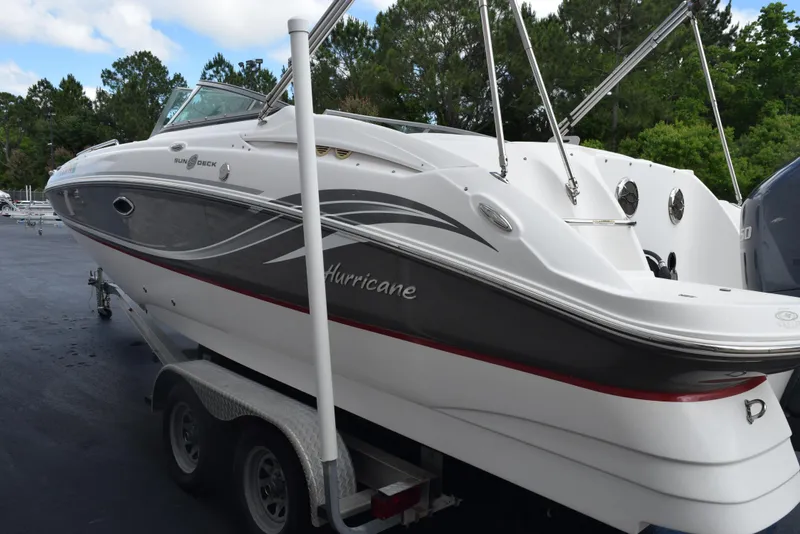 Slide: The Image of 2012 Hurricane SD2200 O/B boat on trailer, white and gray design, parked outdoors. - 7