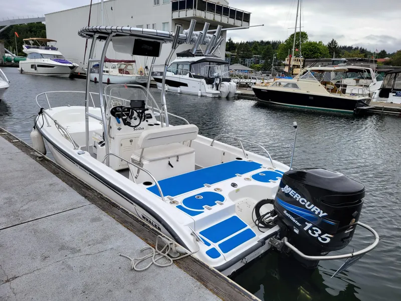 Slide: The Image of 2005 Boston Whaler 180 Dauntless boat docked, featuring a Mercury 135 outboard engine. - 3