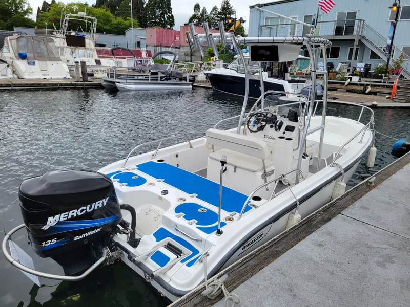 Slide: The Image of 2005 Boston Whaler 180 Dauntless boat docked, featuring Mercury 135 outboard engine. - 5
