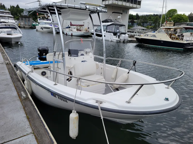 Slide: The Image of 2005 Boston Whaler 180 Dauntless boat docked in a marina. - 8