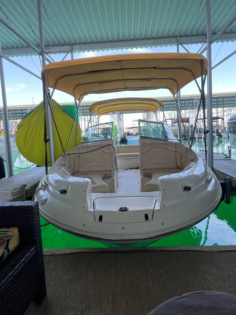 Slide: The Image of 2002 Sea Ray 270 Sundeck boat with canopy, docked in a covered marina. - 17