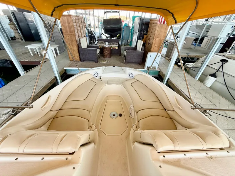 Slide: The Image of 2002 Sea Ray 270 Sundeck boat interior with beige seating and yellow canopy. - 4