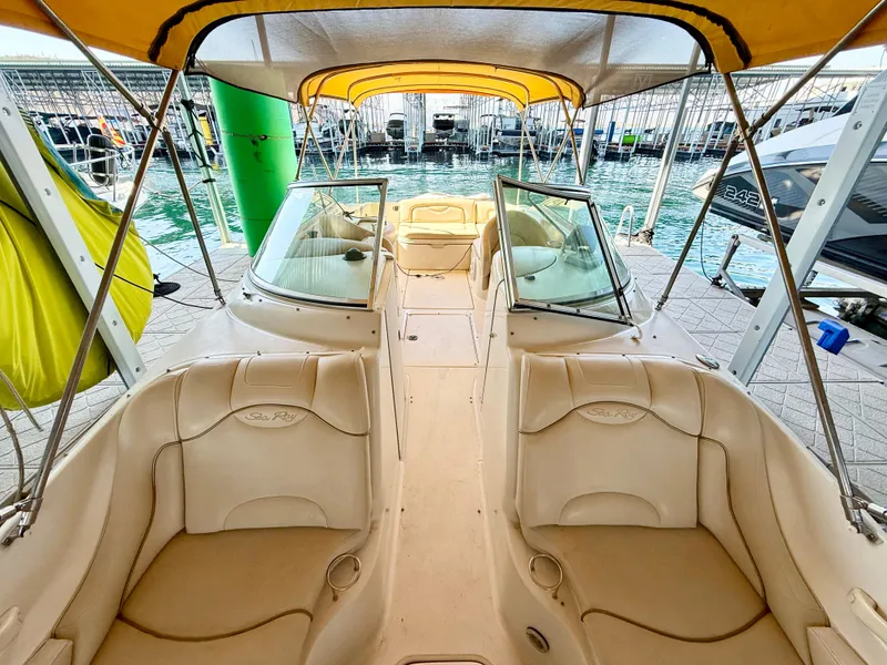 Slide: The Image of 2002 Sea Ray 270 Sundeck boat interior with beige seating and canopy. - 5