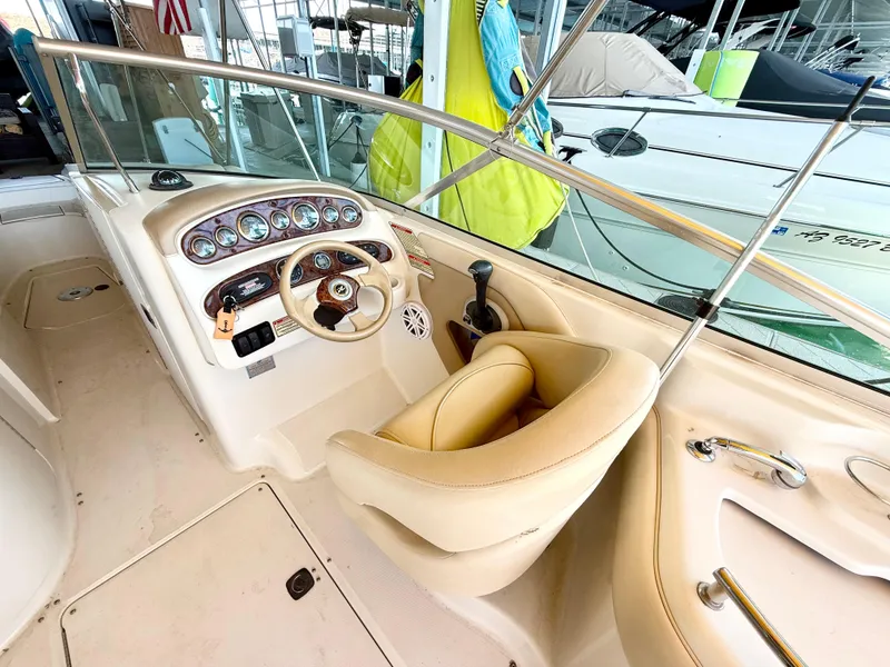 Slide: The Image of 2002 Sea Ray 270 Sundeck boat cockpit with steering wheel and gauges. - 7