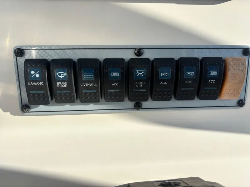 Slide: The Image of Control panel of a 2018 Key West 203 FS boat with labeled switches. - 21