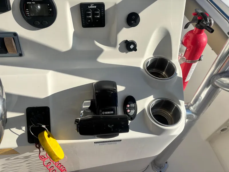 Slide: The Image of Control panel of 2018 Key West 203 FS boat with Yamaha throttle and fire extinguisher. - 23