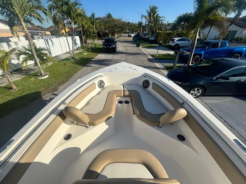 Slide: The Image of 2018 Key West 203 FS boat with tan seating, parked on a residential street. - 26